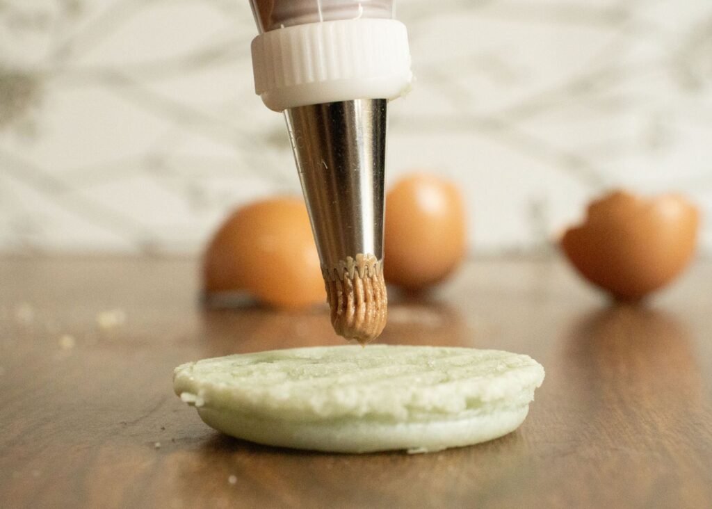 Spuitmondjes opbergen opzetstukken: metalen spuitmondje met koppelstuk boven een macaronschelp